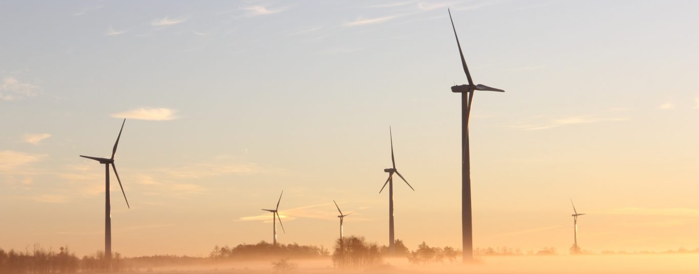 wind turbines against sunset