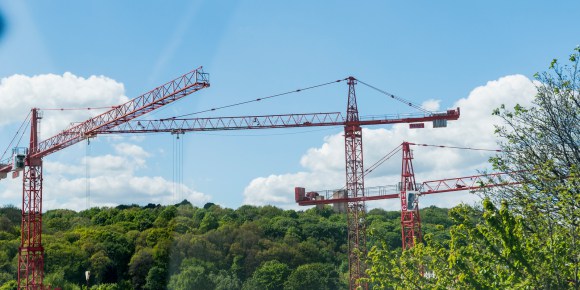 Image shows cranes looms larger using in construction in Sheffield region.