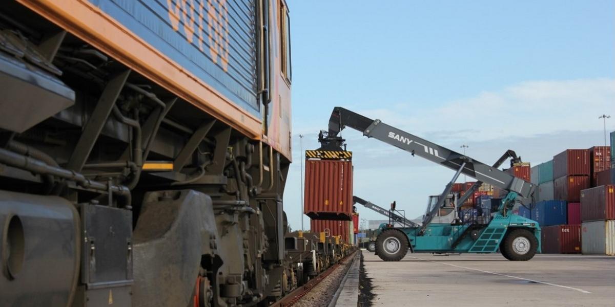 Picture of port, lifting a container with crane.